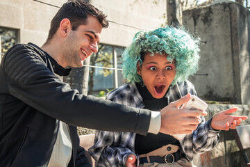 couple looking at mobile phone checking with surprise