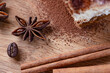 beautiful composition of anise, brown sugar, cinnamon and coffee beans on a wooden background