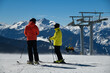 Skiers overlooking to the panoramic view of Vail ski resort in winter time in the Colorado Rocky Mountains