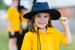 © Clare Seibel-Barnes/Austockphoto - Portrait of a happy young school girl outside wearing a hat for sun protection
