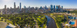 © Gary Chapman/Austockphoto - Aerial view of a wide river winding towards a city with parkland along side