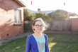 © Nicole Hastings/Austockphoto - Young girl standing under washing line smiling