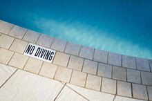 Warning Sign At Edge Of Swimming Pool