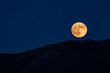 © STEVE SMITH/Tetra Images - USA, Idaho, Bellevue, Full moon rising over hills