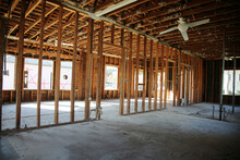 Home Or Building Demolition. Remodeling Of A Home Or Office Building. An Empty Building With The Walls And Appliances Removed. Bare Wood Frame Inside An Old Building During A Remodeling Job