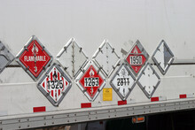 Various Hazard Plackards On The Side Of A Truck