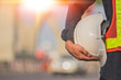 © Suriyo - Engineer holding helmet on site Road construction For the development of modern transportation systems, Technician worker hold hard hat safety first