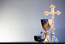 Religion Theme – Easter. Catholic Symbols Composition. The Cross, Monstrance  And Golden Chalice On Blue Background. 