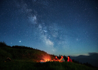 Wall Mural - recreation under night full starry sky in the mountains.