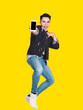 © Tom Wang - Happy handsome  young man showing the smart phone and jumping