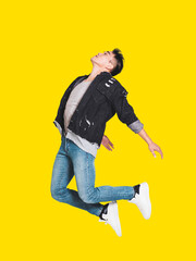 Wall Mural - Happy handsome  young man in casual clothes smiling and jumping