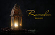 Muslim lamp and tasbih on dark background. Celebration of Ramadan