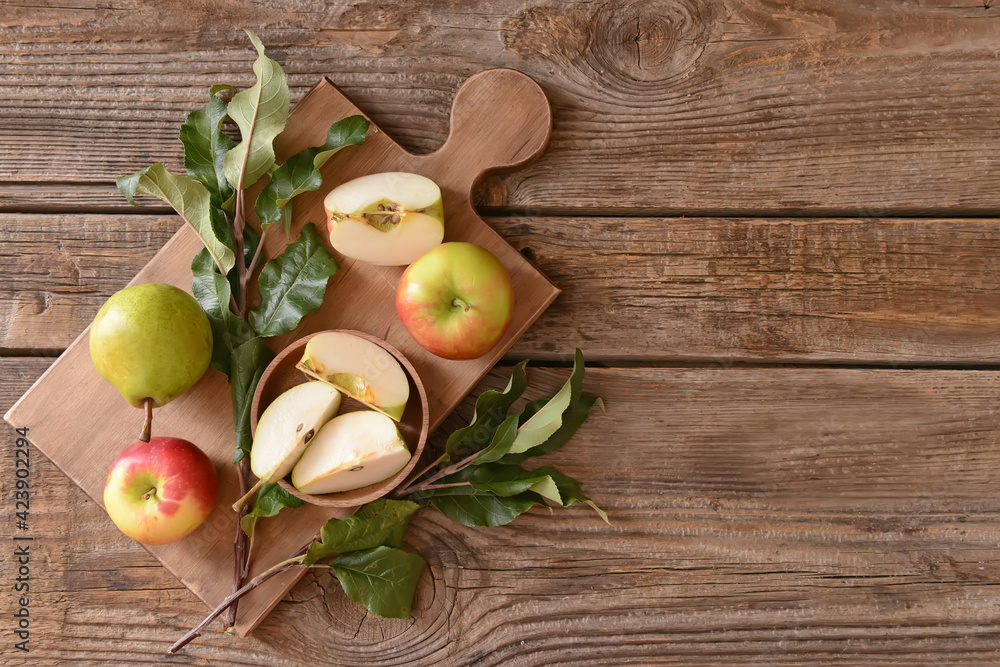 Board with tasty apple and pear fruits on table