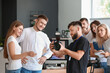 © Pixel-Shot - Mentor teaching young photographers in studio