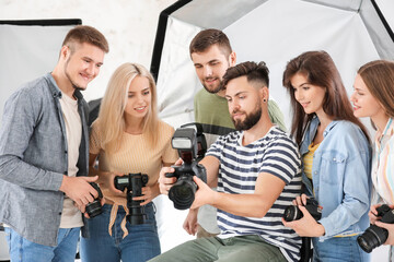 Wall Mural - Mentor teaching young photographers in studio