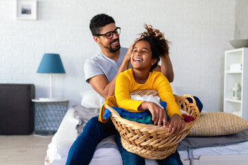 Black Daughter helping father do household and domestic chores together