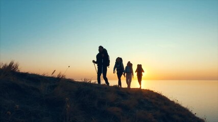 Wall Mural - the four travelers walking on the mountain top near the sea. slow motion