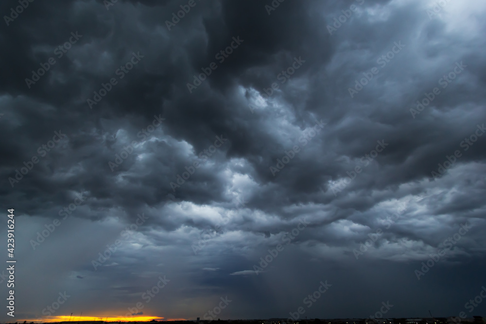 The dark sky had clouds gathered to the left and a strong storm before ...