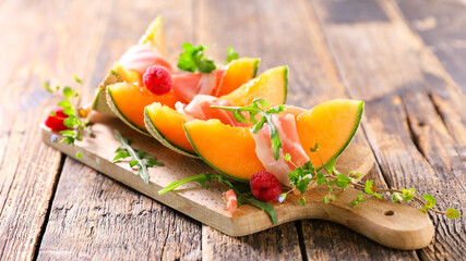Poster - melon slices with prosciutto ham on board