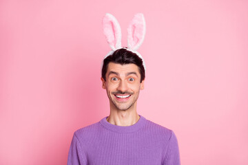 Sticker - Photo of excited funny young guy wear violet sweater easter bunny ears isolated pink color background