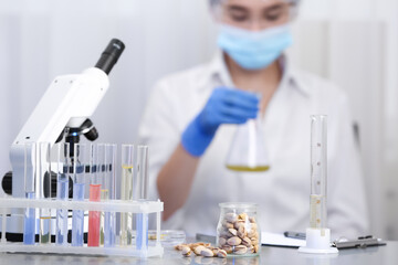 Wall Mural - pistachios on table and scientist proceeding quality control in laboratory