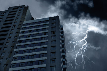 Wall Mural - dark cloudy sky with lightning over building. stormy weather