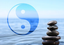 Stack Of Stones In Water And Ying Yang Symbol. Feng Shui Philosophy