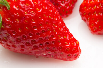 Two strawberries close up on white background