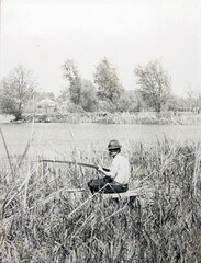 Wall Mural - old vintage photo man with a fishing rod