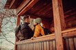 © Minet - Loving man and woman standing in their cottage room balcony