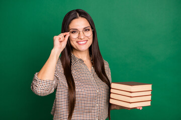 Sticker - Photo of cheerful positive lady hold pile book wear eyeglasses checkered shirt isolated green color background