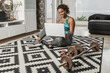 © Juan Algar - Black sportswoman watching online tutorial before training