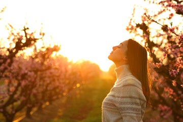 Woman breathing at sunrise in a field