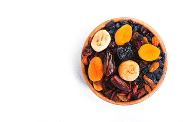 Wall Mural - Healthy food snack: dried fruits, natural. sun dried organic mix of dried apricots, figs, raisins, dates, cranberries, cherries, goji berries, prunes in bowls on white background, top view