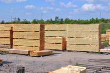 Stacked Timber In Outdoor Builders Supply Yard With Blue Sky 