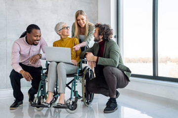 Wall Mural - Business people with disabiliy working on new project together in office