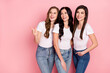 © deagreez - Photo of three young attractive girls happy positive smile look empty space laugh isolated over pink color background