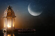 © Pixel-Shot - Muslim lamp and tasbih on table against night sky