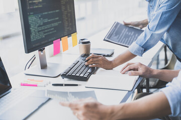 Wall Mural - programming developing software application. programmer writing program code with two monitors and w