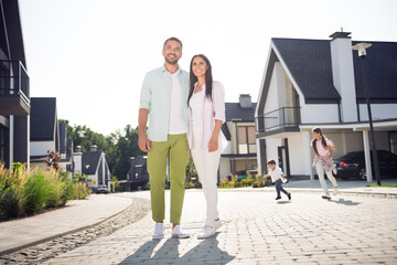 Full length body size view of four lovely cheery people family hugging move new home buying american dream in cottage town outdoor