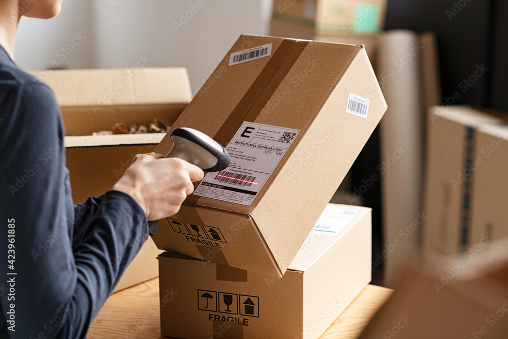Scanning parcel barcode before shipment - obrazy, fototapety, plakaty 