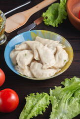 Wall Mural - homemade natural farm dumplings and dumplings on the table with vegetables and herbs.