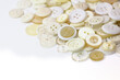 © Repli-Kate - White and beige buttons on a white background. Old vintage buttons close up. Copy space. Side view. The background is made of buttons in natural shades.