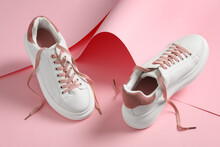 Pair Of Stylish Shoes With Laces On Pink Paper Background