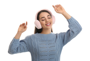 Wall Mural - Beautiful young woman wearing earmuffs on white background