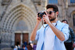 © BullRun - Focused man taking photo on camera