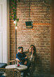 © Olena - mother and son laugh in a loft style cafe