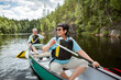 © Suzi Media  - Happy mature couple in life vests canoeing in forest lake. Sunny summer day. Tourists traveling in Finland, having adventure.