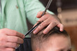 © gargantiopa - Barber in barbershop cuts hair happy child boy. Lifestyle close-up. Concept of beauty, hygiene and care salon