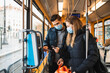 © Maskot - Heterosexual couple buying ticket in tram during pandemic